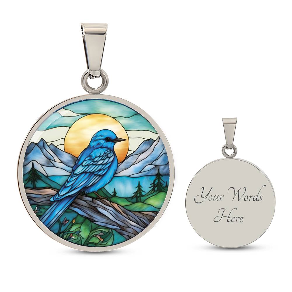 an Elegant silver pendant Blue Bird necklace. Colors blue bird and water, yellow sun, green trees and grass, brown branch, blue and white sky/ mountains. This jewelry offers personalization with an engraving option for a name.