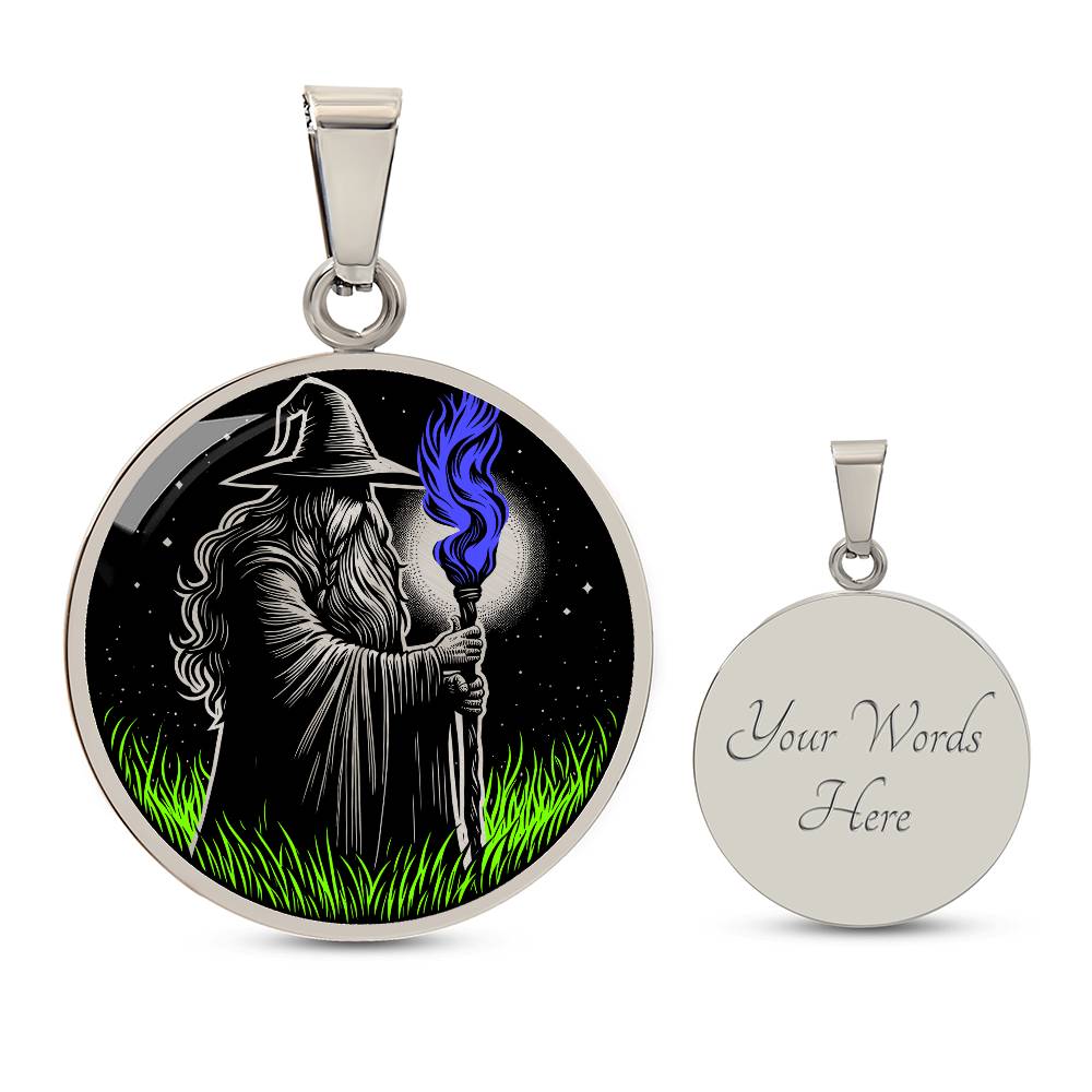An Elegant silver pendant featuring a Fantasy Wizard Necklace, with green grass, blue fire with a silver and black background. This jewelry offers personalization with an engraving option for a name.