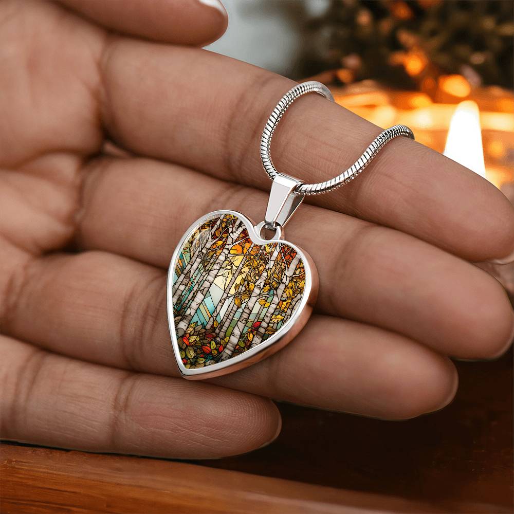 Heart Birch Tree Necklace in a woman's hand