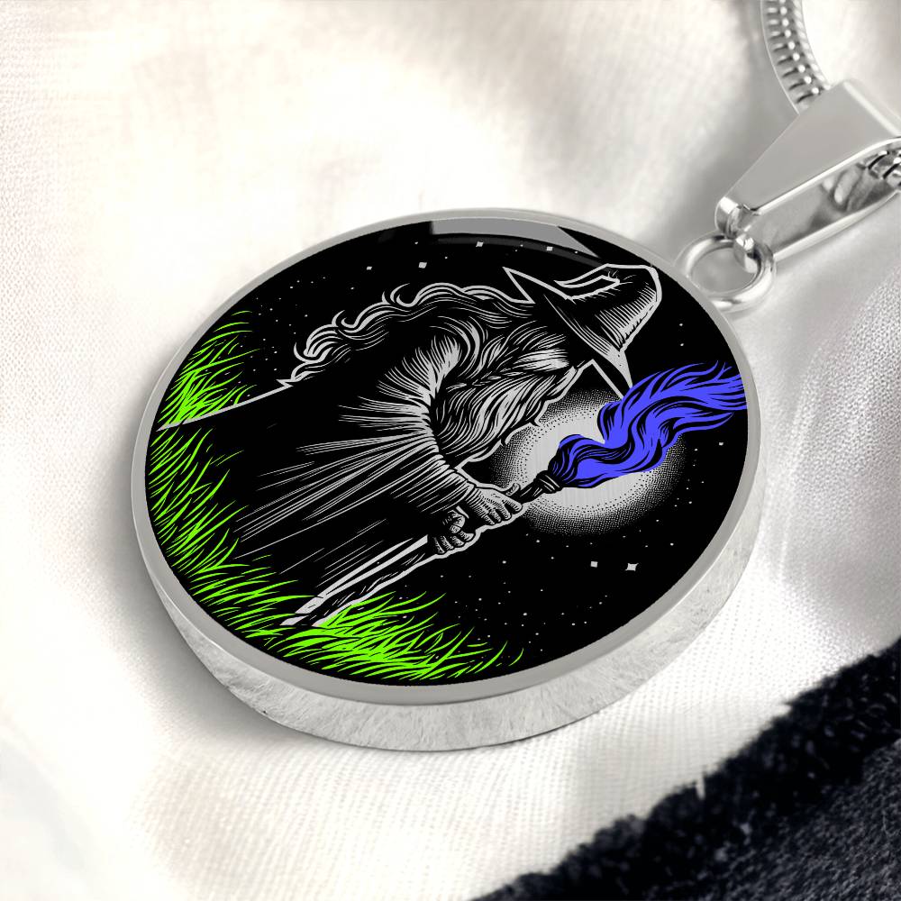 An Elegant silver pendant featuring a Fantasy Wizard Necklace, with green grass, blue fire with a silver and black background. This jewelry offers personalization with an engraving option for a name.