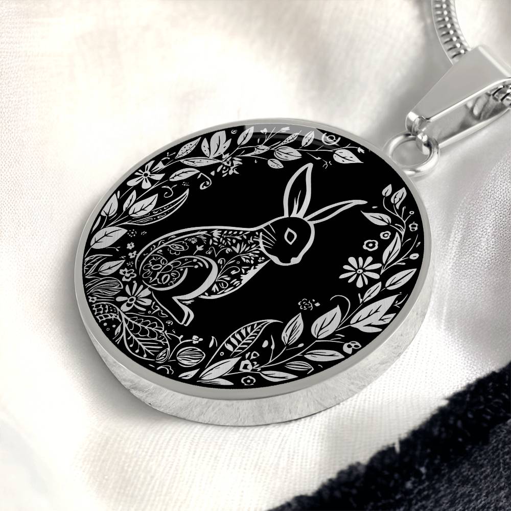 Elegant silver pendant Easter Bunny necklace featuring Silver bunny with leaves and flowers all in silver with a black background. This jewelry offers personalization with an engraving option for a name.