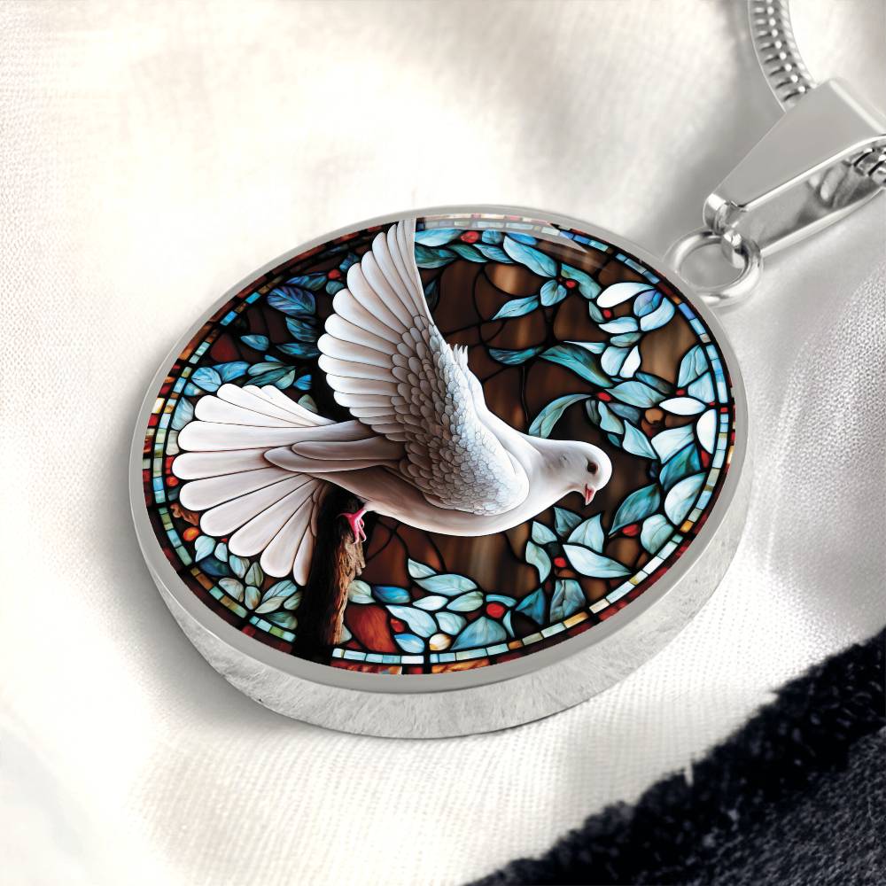 an Elegant silver pendant Dove Bird Necklace. featuring a white dove, green, blue, red colored border, leaves, berries with a brown background. This jewelry offers personalization with an engraving option for a name.
