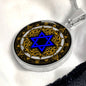 An Elegant silver pendant featuring a Vintage Design with a vivid blue Star of David Necklace, set against a gold, silver and black backdrop. This jewelry offers personalization with an engraving option for a name.
