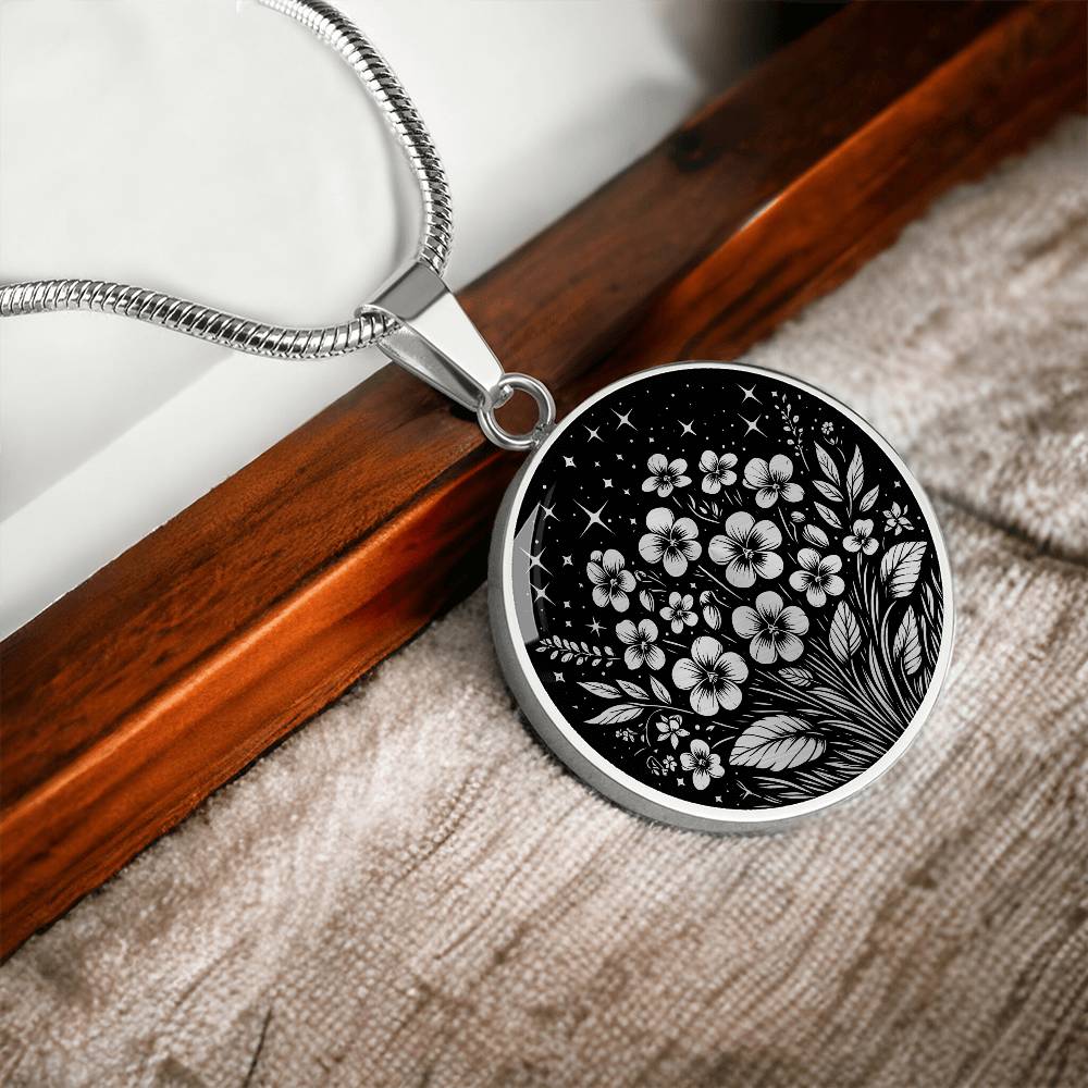 an Elegant silver pendant featuring a vivid African Violet Birth Flower Necklace, set against a subtle Silver and Black backdrop. This jewelry offers personalization with an engraving option for a name.