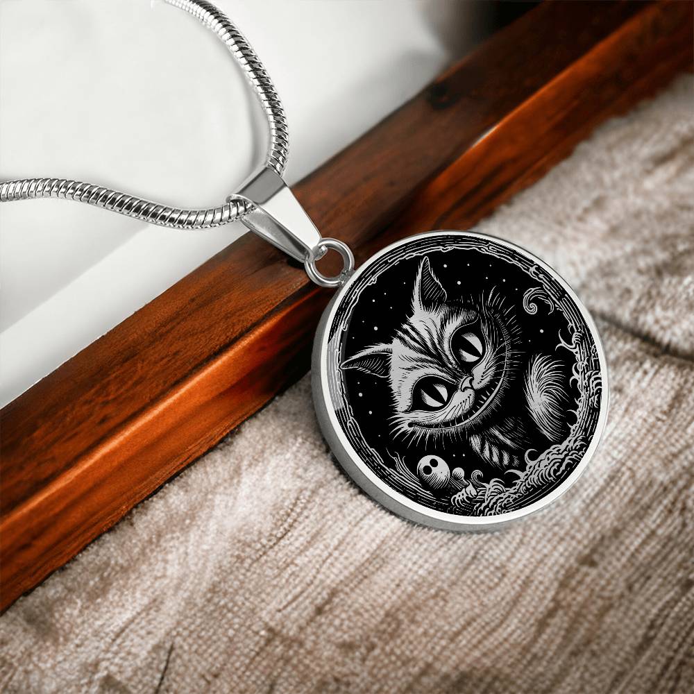 An elegant silver pendant Cheshire Cat Necklace. The colors are gold and black. This necklace offers personalization with an engraving option for a name.