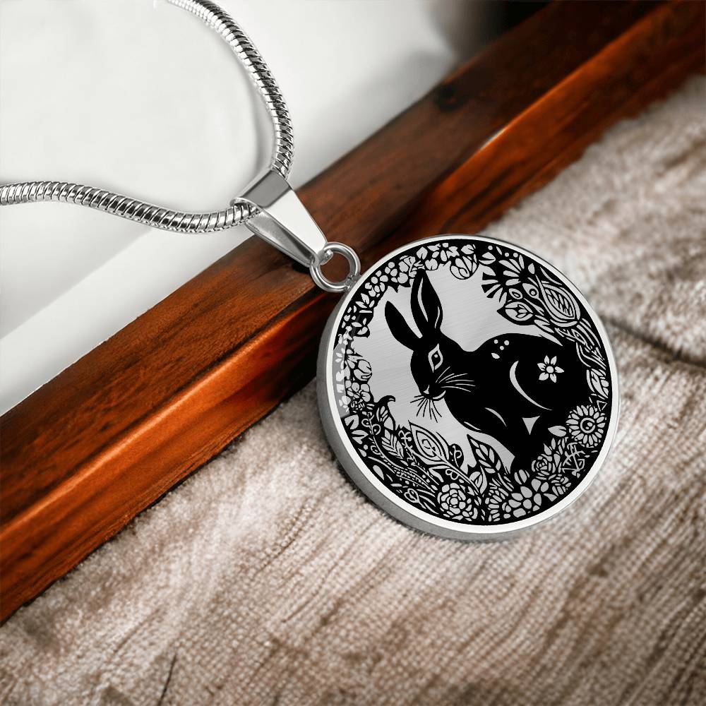 Elegant silver pendant Easter Bunny necklace featuring Silver bunny with leaves and flowers all in silver with a black background. This jewelry offers personalization with an engraving option for a name.