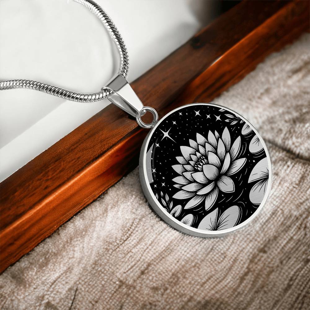 An Elegant silver pendant Water Lily Necklace featuring Stars, Lily Pads and a Water lily, all in black and silver. This jewelry offers personalization with an engraving option for a name.