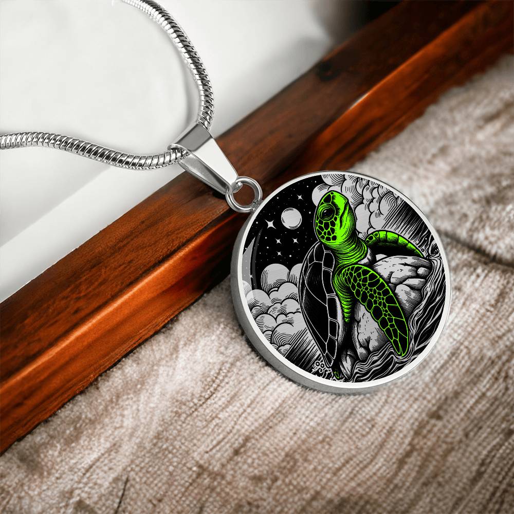 Elegant silver pendant featuring a vivid Green Turtle Necklace with a moon, Stars, Clouds and Ocean set against a black backdrop. This jewelry offers personalization with an engraving option for a name.
