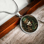 an Elegant silver pendant Medusa necklace. The colors are green hair, white skin, brown background. This jewelry offers personalization with an engraving option for a name.