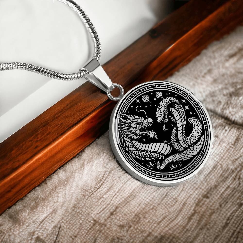 An Elegant silver pendant featuring a Year of the Snake and Year of The Dragon Necklace in silver and black. This jewelry offers personalization with an engraving option for a name.