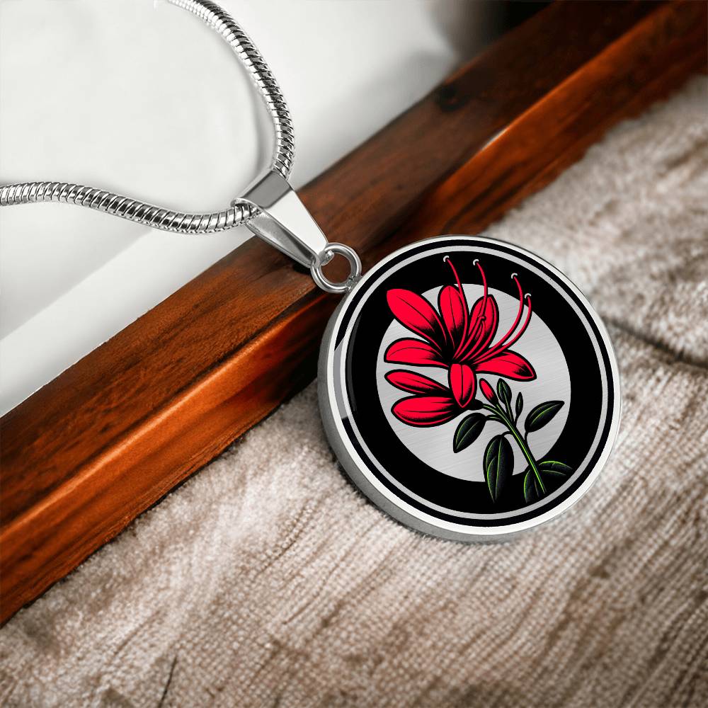 Elegant silver pendant featuring a vivid red honeysuckle, Junes birth month flower, set against a subtle tan backdrop. This necklace offers personalization with an engraving option for a name.