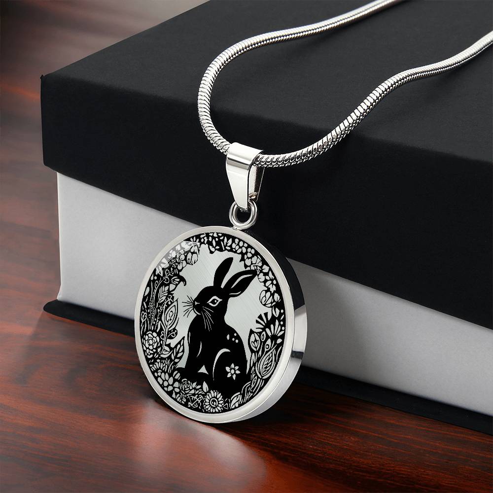 Gift box with an Elegant silver pendant Easter Bunny necklace featuring Silver bunny with leaves and flowers all in silver with a black background. This jewelry offers personalization with an engraving option for a name.