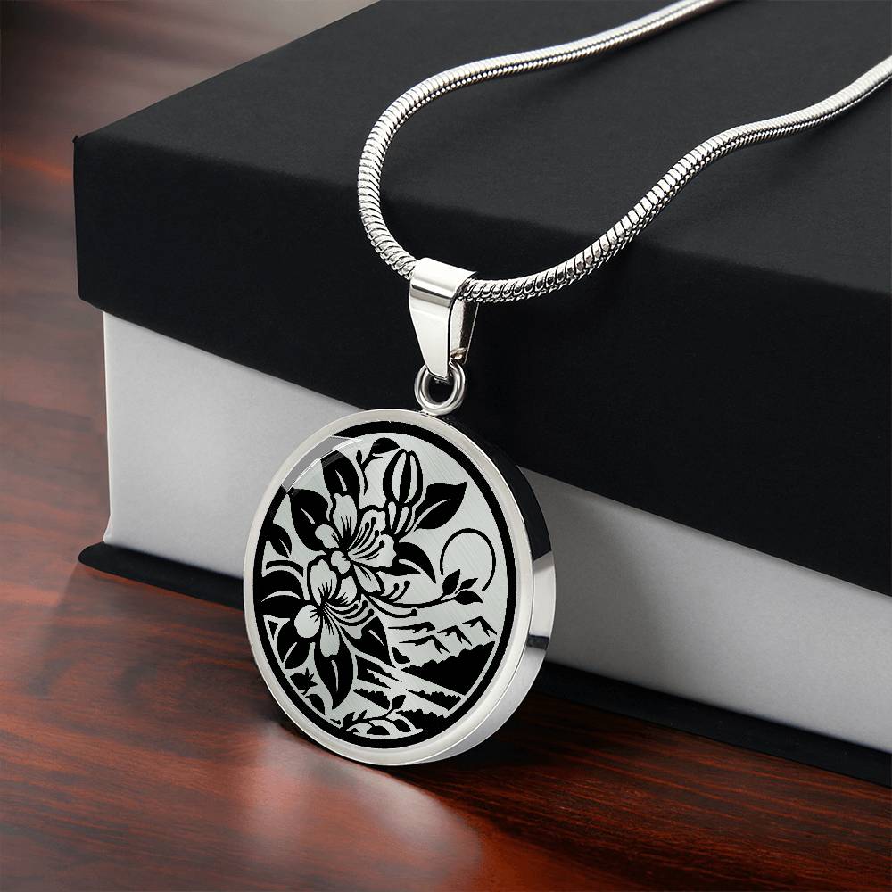 Gift box with an Elegant silver pendant featuring a honeysuckle, silhouette Junes birth month flower, set against a gold or silver backdrop. This necklace offers personalization with an engraving option for a name.
