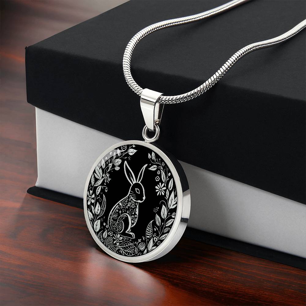 Gift box with an Elegant silver pendant Easter Bunny necklace featuring Silver bunny with leaves and flowers all in silver with a black background. This jewelry offers personalization with an engraving option for a name.
