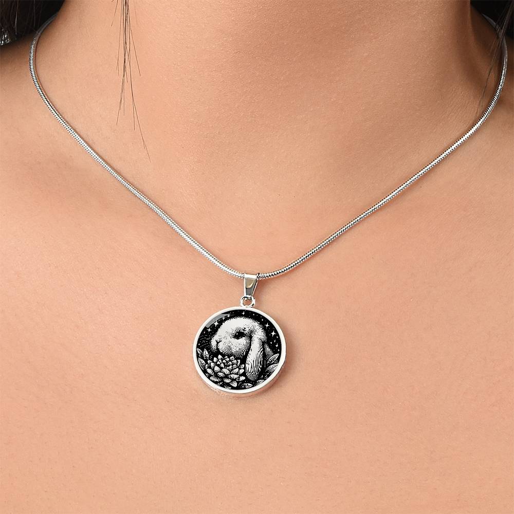 Woman wearing an Elegant silver pendant Water Lily Bunny necklace. Colors are silver with a black background. This jewelry offers personalization with an engraving option for a name.