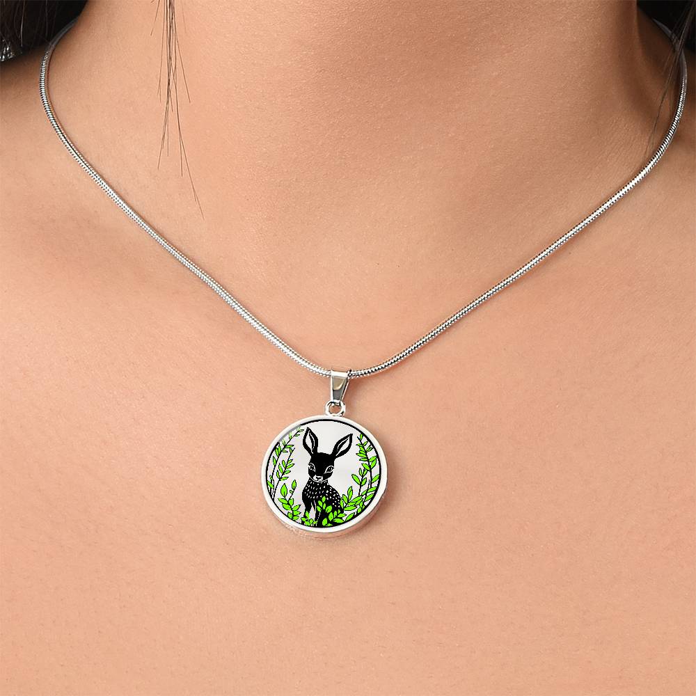 Woman wearing An Elegant silver pendant Deer Necklace. All in Silver and black with green leaves. This jewelry offers personalization with an engraving option for a name.