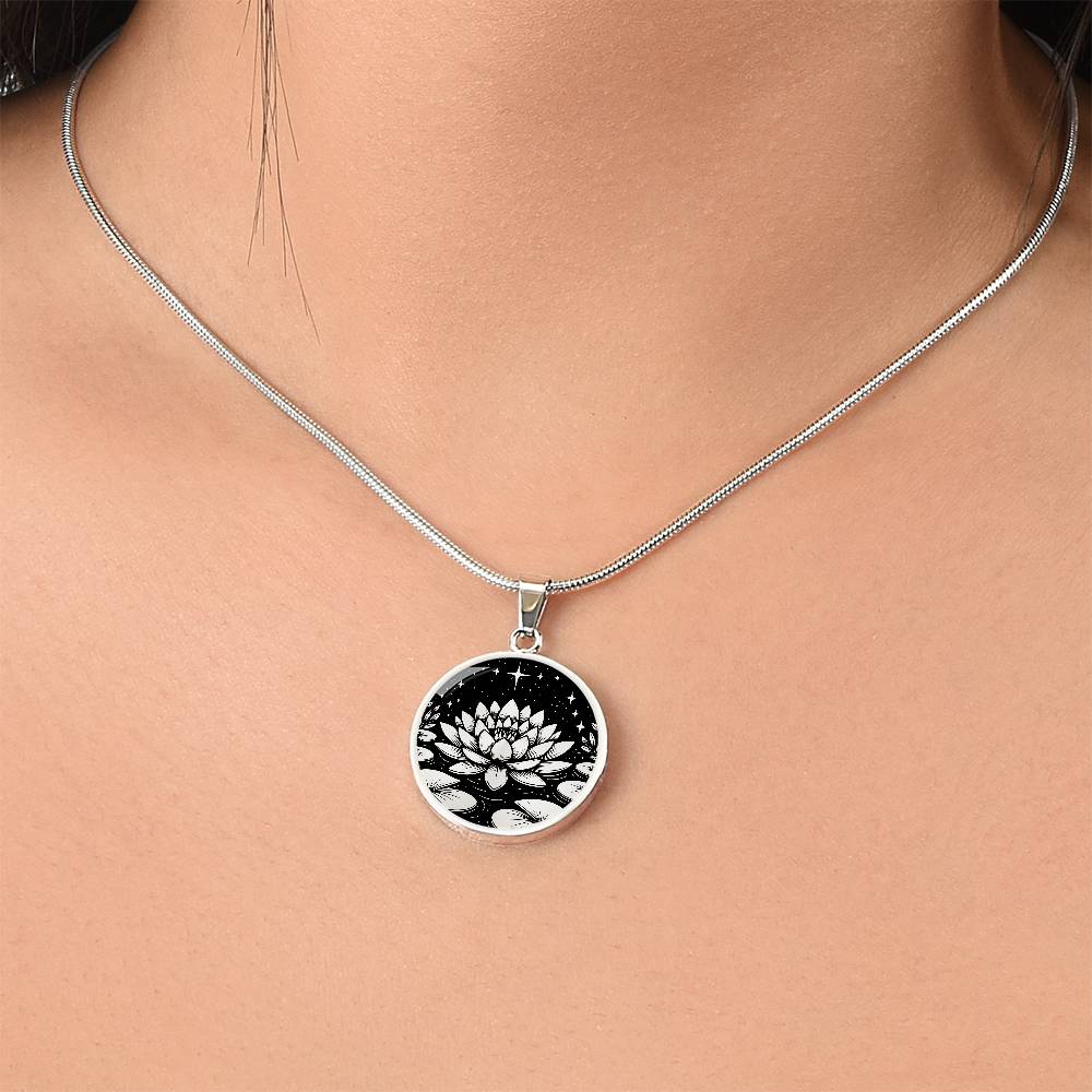 Woman wearing An Elegant silver pendant Water Lily Necklace featuring Stars, Lily Pads and a Water lily, all in black and silver. This jewelry offers personalization with an engraving option for a name.