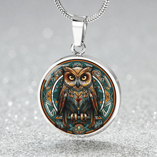 An elegant silver pendant featuring a Celtic Owl Necklace, set against a Green and orange backdrop. This jewelry offers personalization with an engraving option for a name.