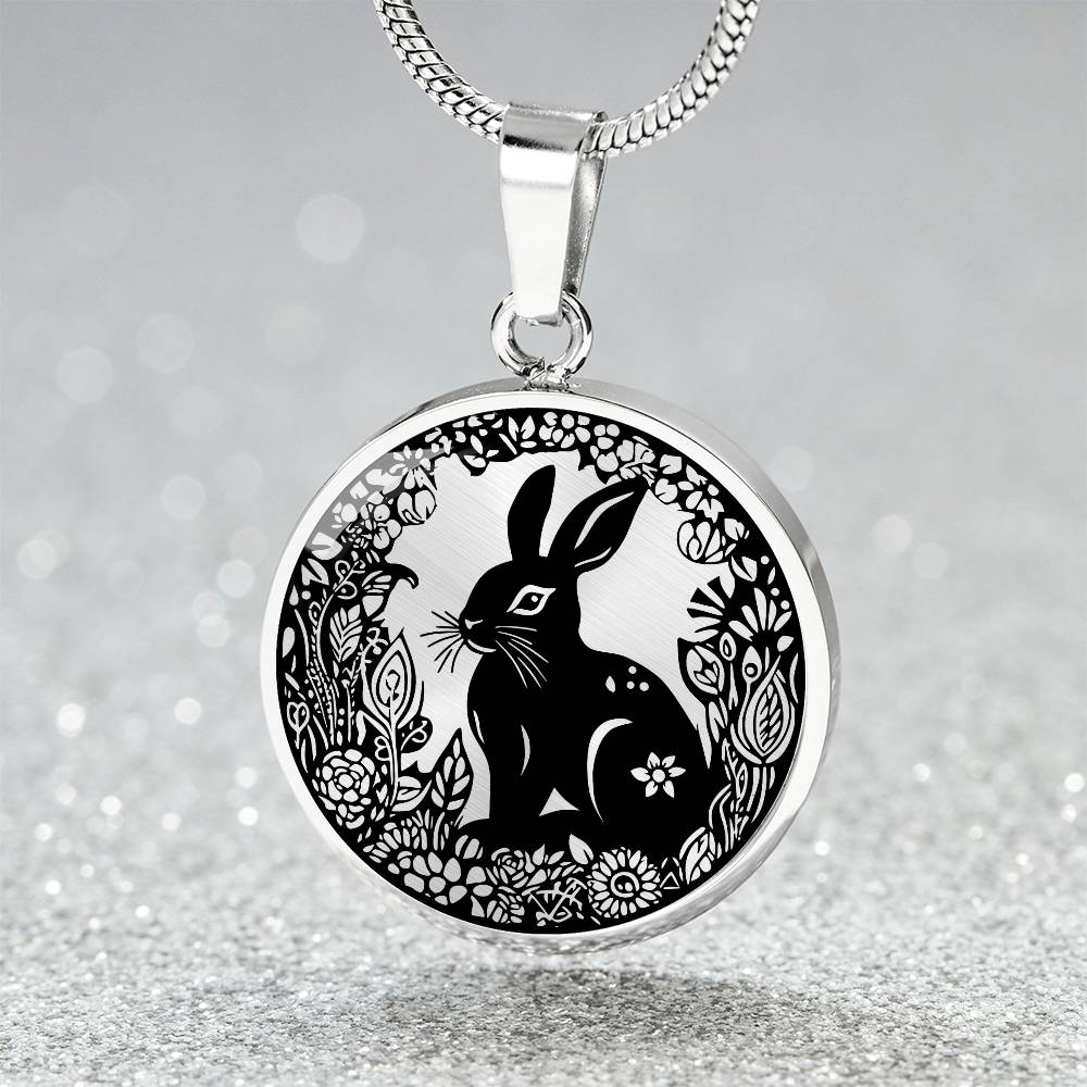 Elegant silver pendant Easter Bunny necklace featuring Silver bunny with leaves and flowers all in silver with a black background. This jewelry offers personalization with an engraving option for a name.