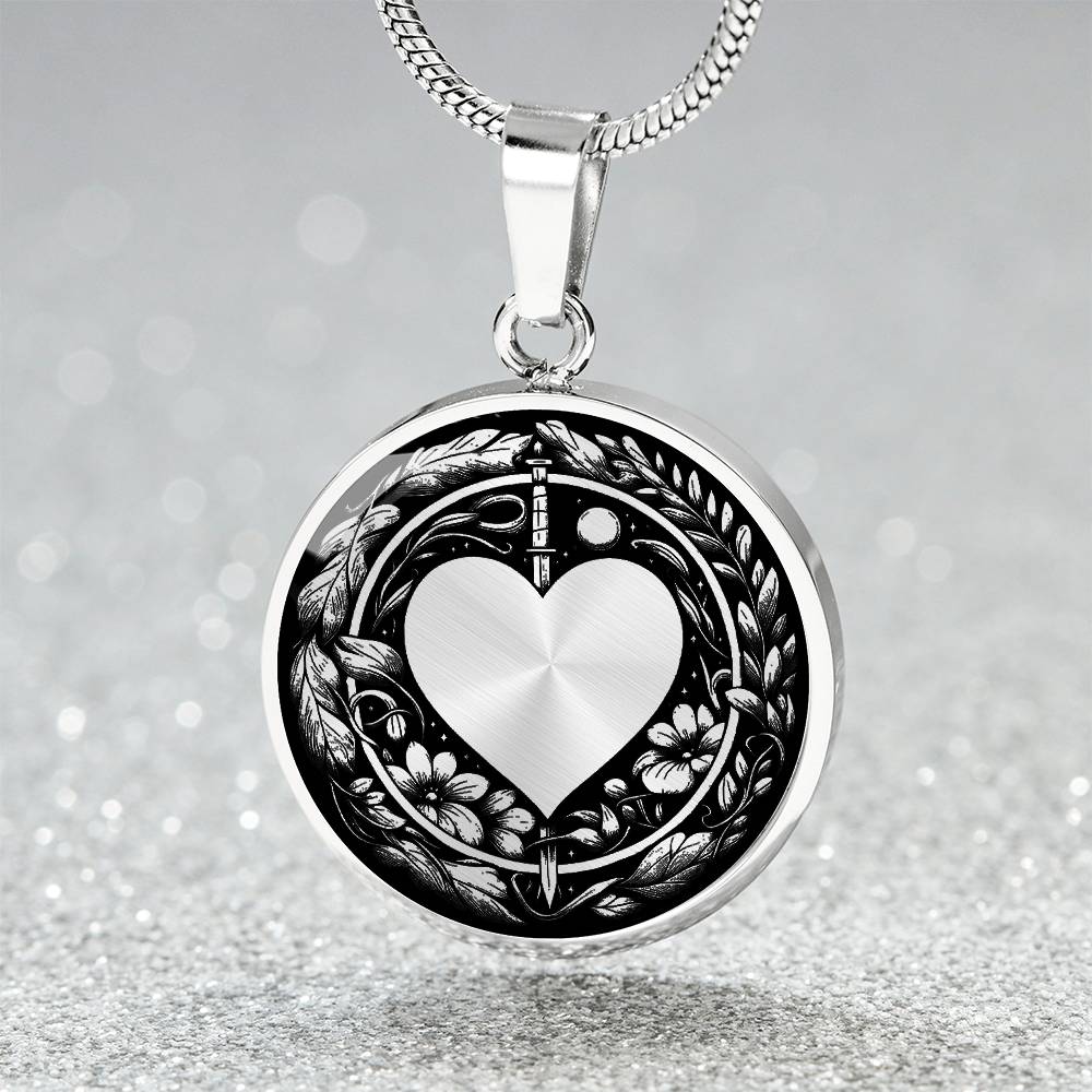 An Elegant silver pendant featuring a Valentines Design with a vivid Silver Moonlight Heart Necklace, set against a silver and black backdrop with a sword and flowers. This jewelry offers personalization with an engraving option for a name.