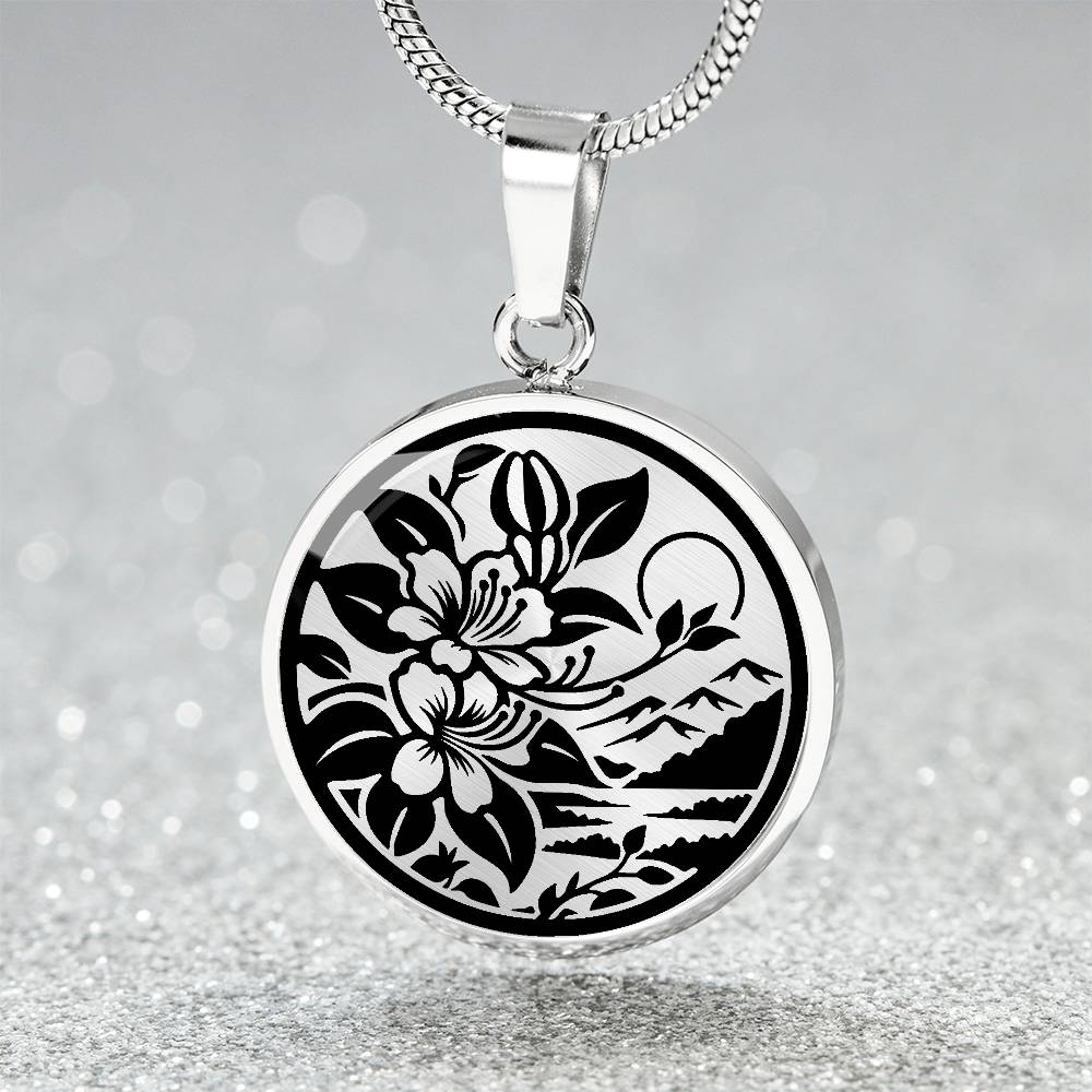 Elegant silver pendant featuring a honeysuckle, silhouette Junes birth month flower, set against a gold or silver backdrop. This necklace offers personalization with an engraving option for a name.