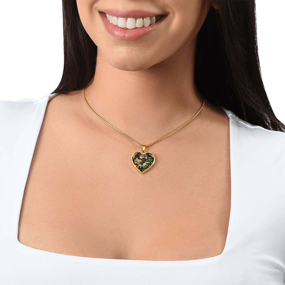 Woman wearing an Elegant gold pendant featuring a yellow/white Daffodil Birth Flower Necklace, March birth month flower, set against a Green & brown backdrop. This jewelry offers personalization with an engraving option for a name.