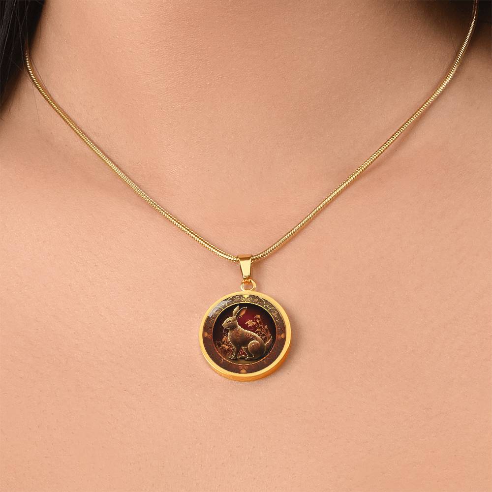 Woman wearing an elegant gold pendant Bunny Rabbit Necklace. The Colors are Red, Yellow and Black. This jewelry offers personalization with an engraving option for a name.