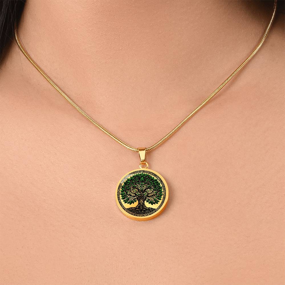 Woman wearing an Elegant gold pendant Celtic Tree of Life Necklace. Colors are black, real gold and Green Leaves. This jewelry offers personalization with an engraving option for a name.