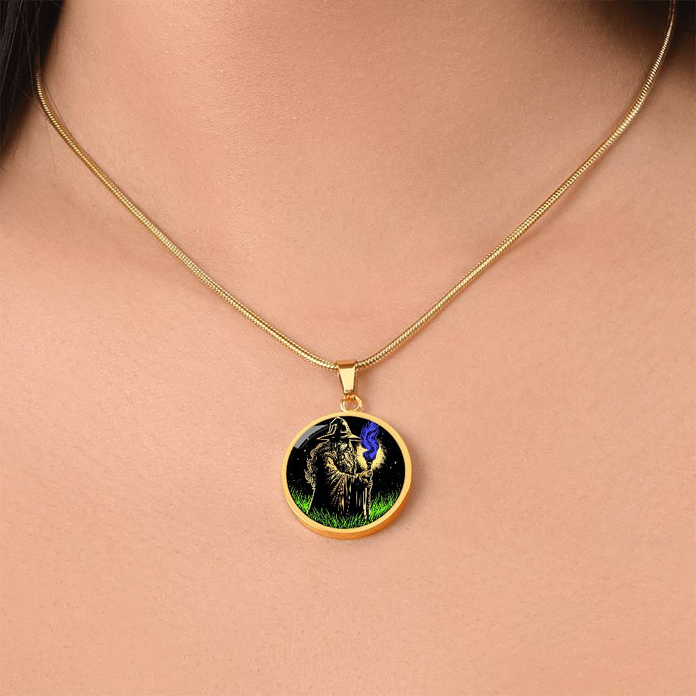 woman wearing An Elegant gold pendant featuring a Fantasy Wizard Necklace, with green grass, blue fire with a gold and black background. This jewelry offers personalization with an engraving option for a name.