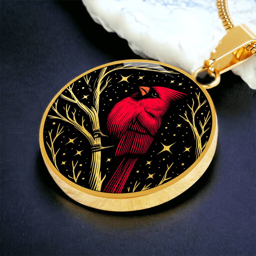 An Elegant gold pendant featuring a vivid Red Northern Cardinal Necklace with Stars and a tree Branch all in a gold and black backdrop. This jewelry offers personalization with an engraving option for a name.