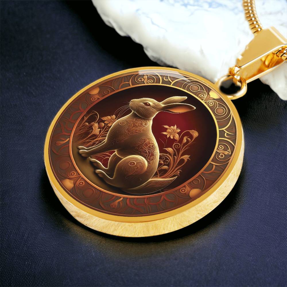 Woman holding an elegant gold pendant Bunny Rabbit Necklace. The Colors are Red, Yellow and Black. This jewelry offers personalization with an engraving option for a name.