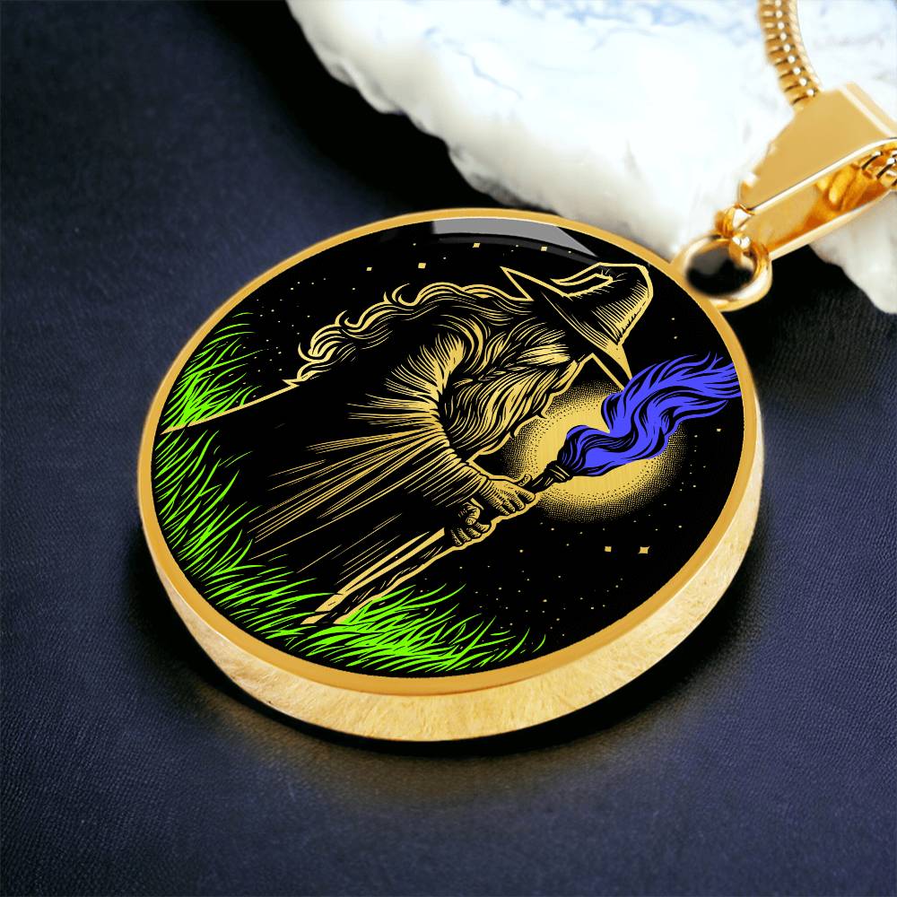An Elegant gold pendant featuring a Fantasy Wizard Necklace, with green grass, blue fire with a gold and black background. This jewelry offers personalization with an engraving option for a name.