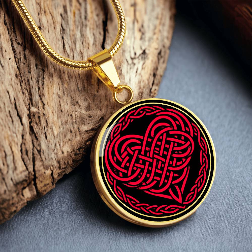 Elegant gold pendant featuring a vivid red Heart Celtic Necklace set against a Black & Gold backdrop. This jewelry offers personalization with an engraving option for a name.