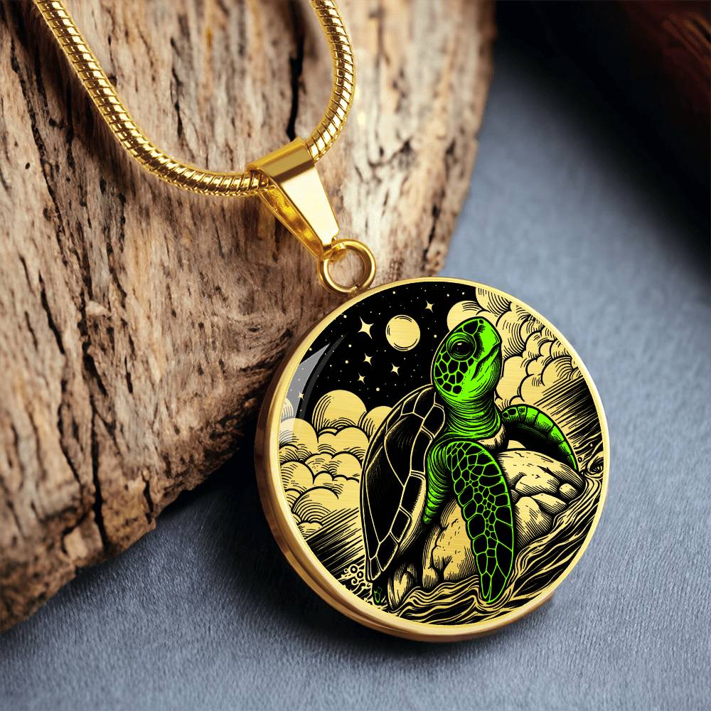 an Elegant gold pendant featuring a vivid Green Turtle Necklace with a moon, Stars, Clouds and Ocean set against a black backdrop. This jewelry offers personalization with an engraving option for a name.