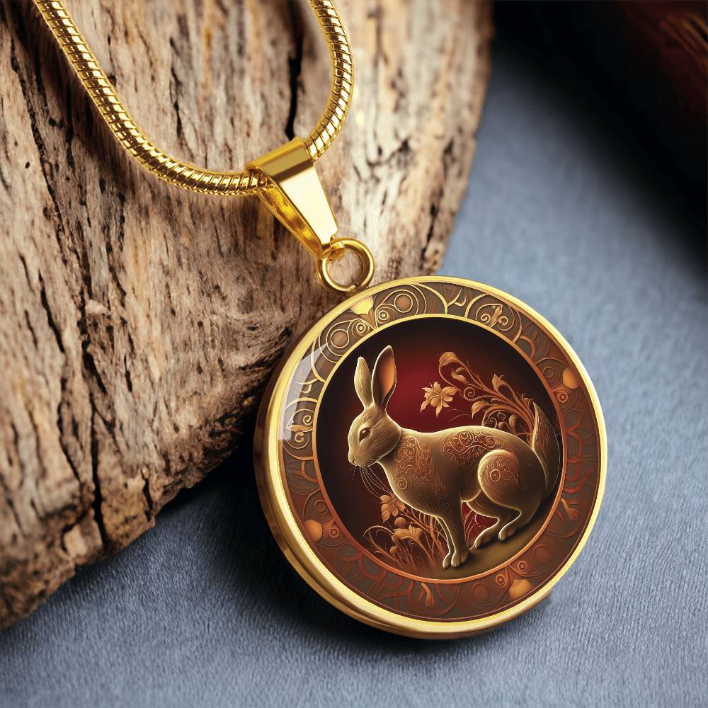 Woman holding an elegant gold pendant Bunny Rabbit Necklace. The Colors are Red, Yellow and Black. This jewelry offers personalization with an engraving option for a name.