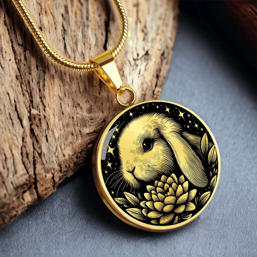an Elegant gold pendant Water Lily Bunny necklace. Colors are gold with a black background. This jewelry offers personalization with an engraving option for a name.