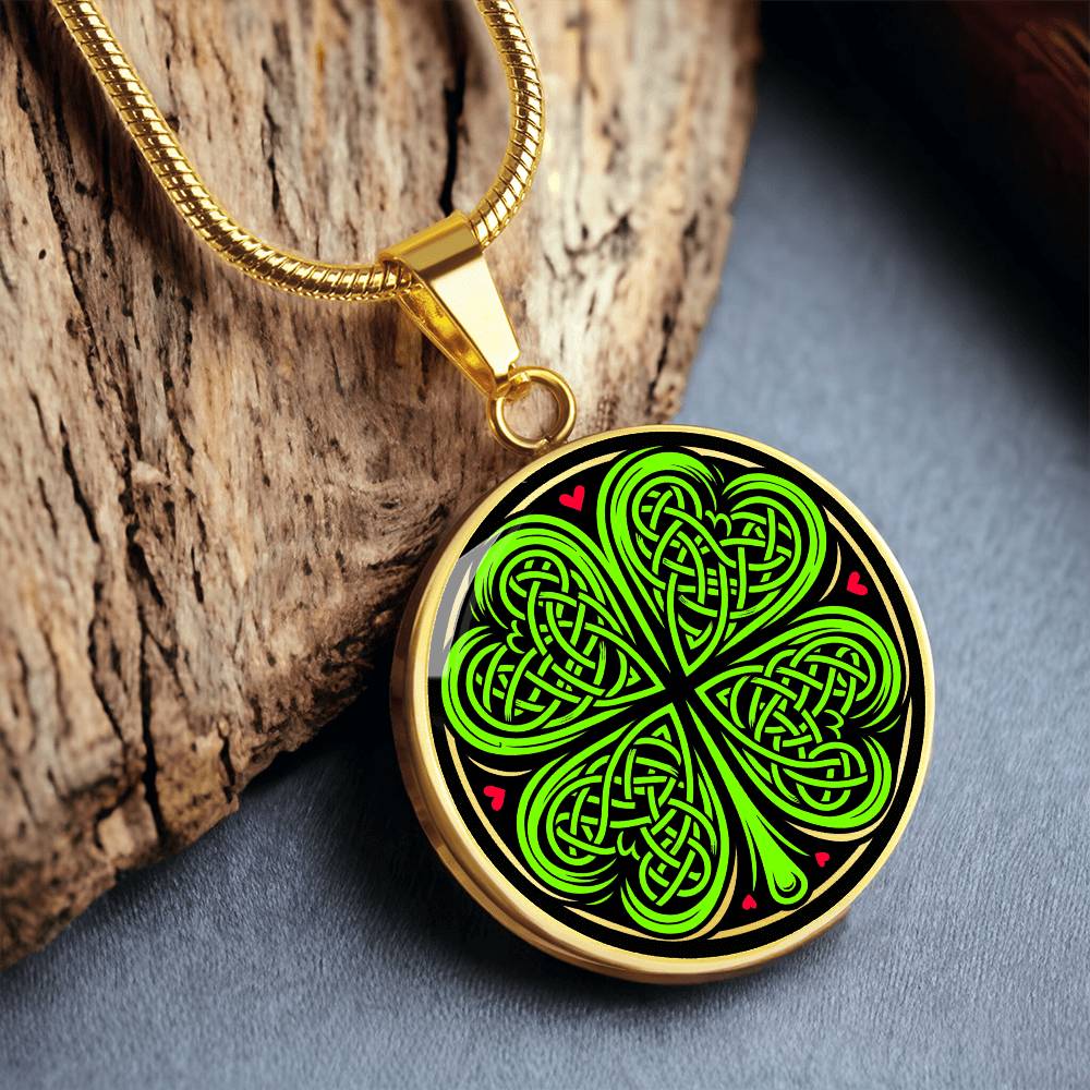 Elegant gold pendant necklace featuring a vivid Celtic four leaf clover with four red & Green hearts, set against a subtle Black & gold backdrop. This jewelry offers personalization with an engraving option for a name.