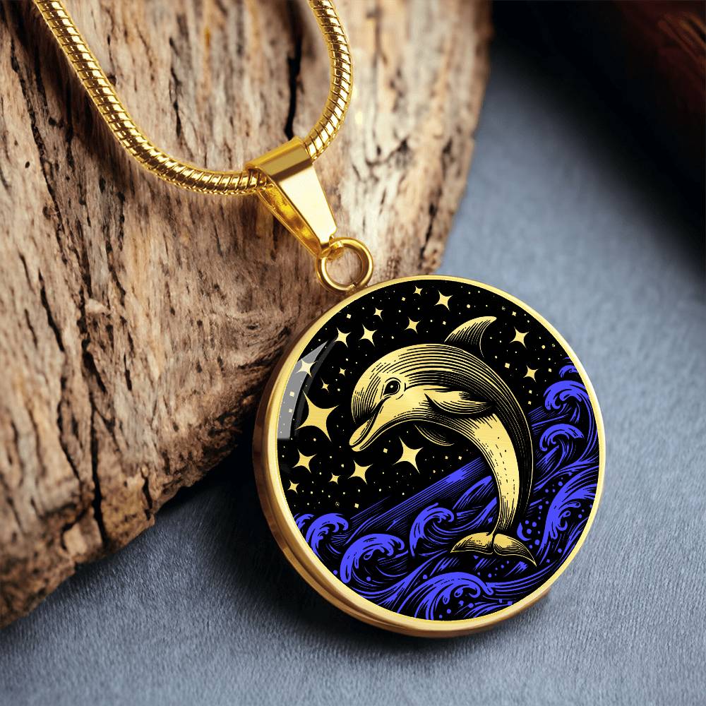an Elegant gold pendant featuring a vivid gold Dolphin Necklace with a Stars and Ocean Waves set against a gold and black backdrop. This jewelry offers personalization with an engraving option for a name.