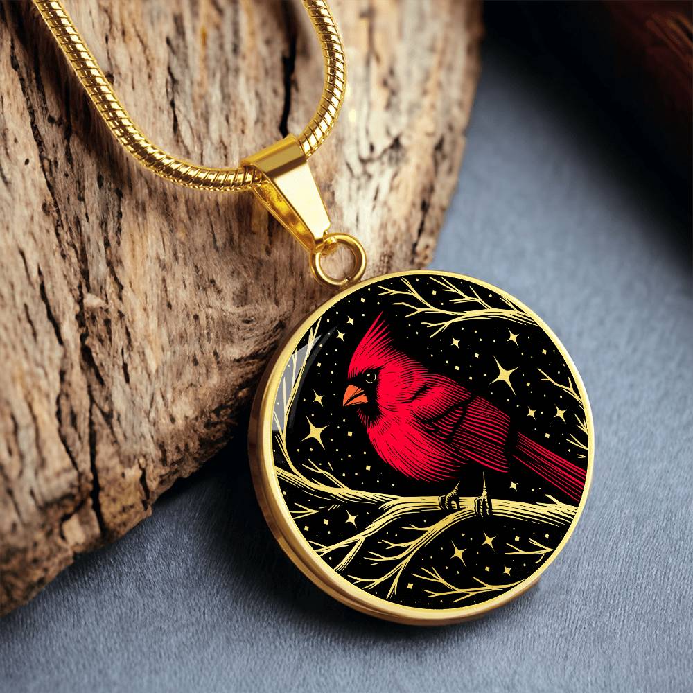 An Elegant gold pendant featuring a vivid Red Northern Cardinal Necklace with Stars and a tree Branch all in a gold and black backdrop. This jewelry offers personalization with an engraving option for a name.