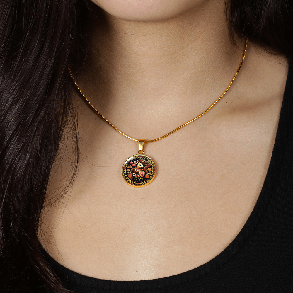 Woman wearing an Elegant gold pendant Year of the Rabbit and Year of the Dragon Necklace. The colors are yellow, Red and Black . This jewelry offers personalization with an engraving option for a name.