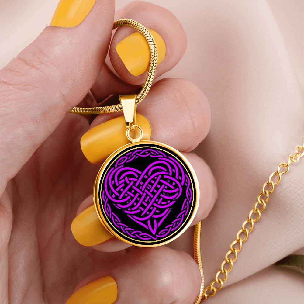 Woman holding an Elegant gold pendant featuring a vivid purple Heart Celtic Necklace set against a Black & Gold backdrop. This jewelry offers personalization with an engraving option for a name.