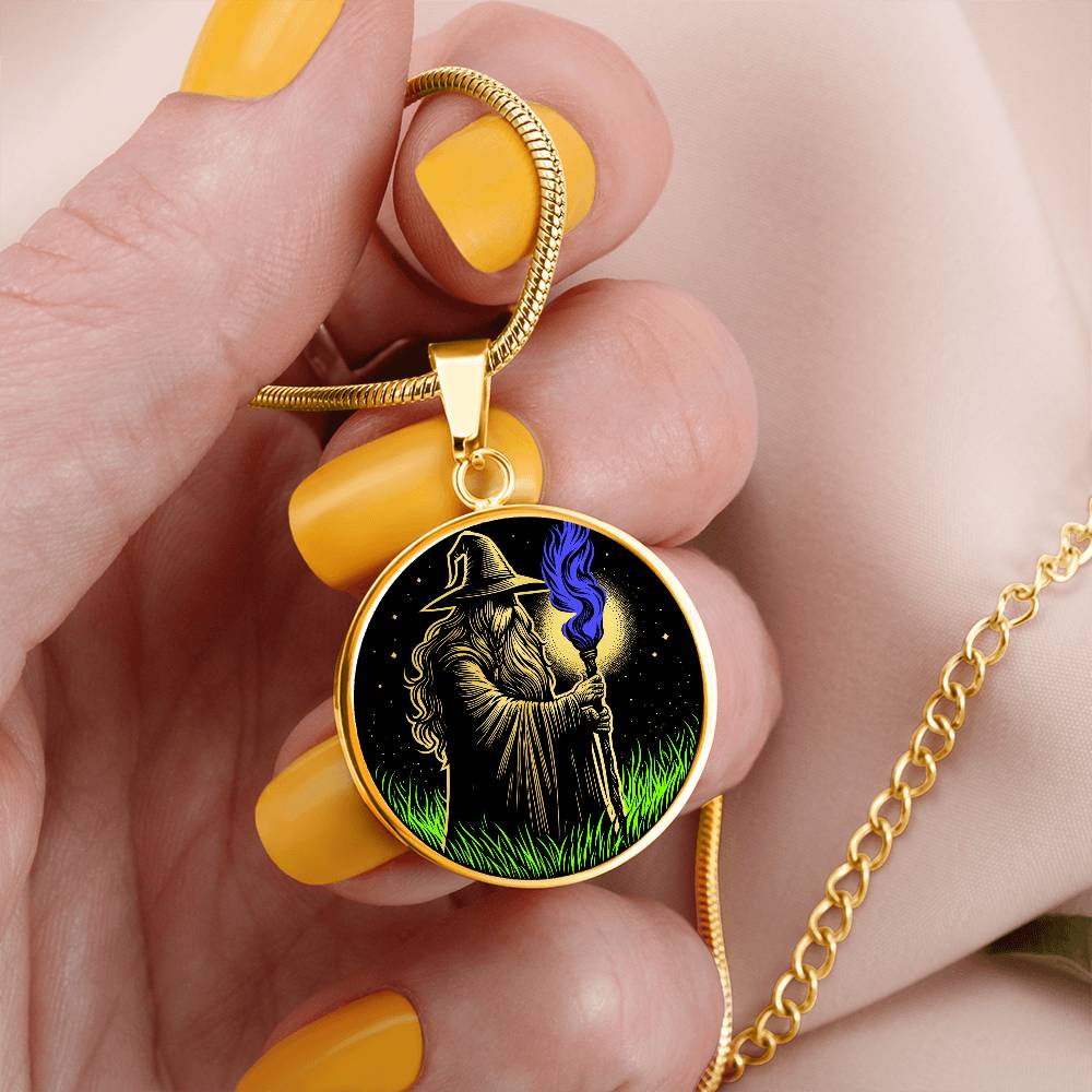 woman holding An Elegant gold pendant featuring a Fantasy Wizard Necklace, with green grass, blue fire with a gold and black background. This jewelry offers personalization with an engraving option for a name.