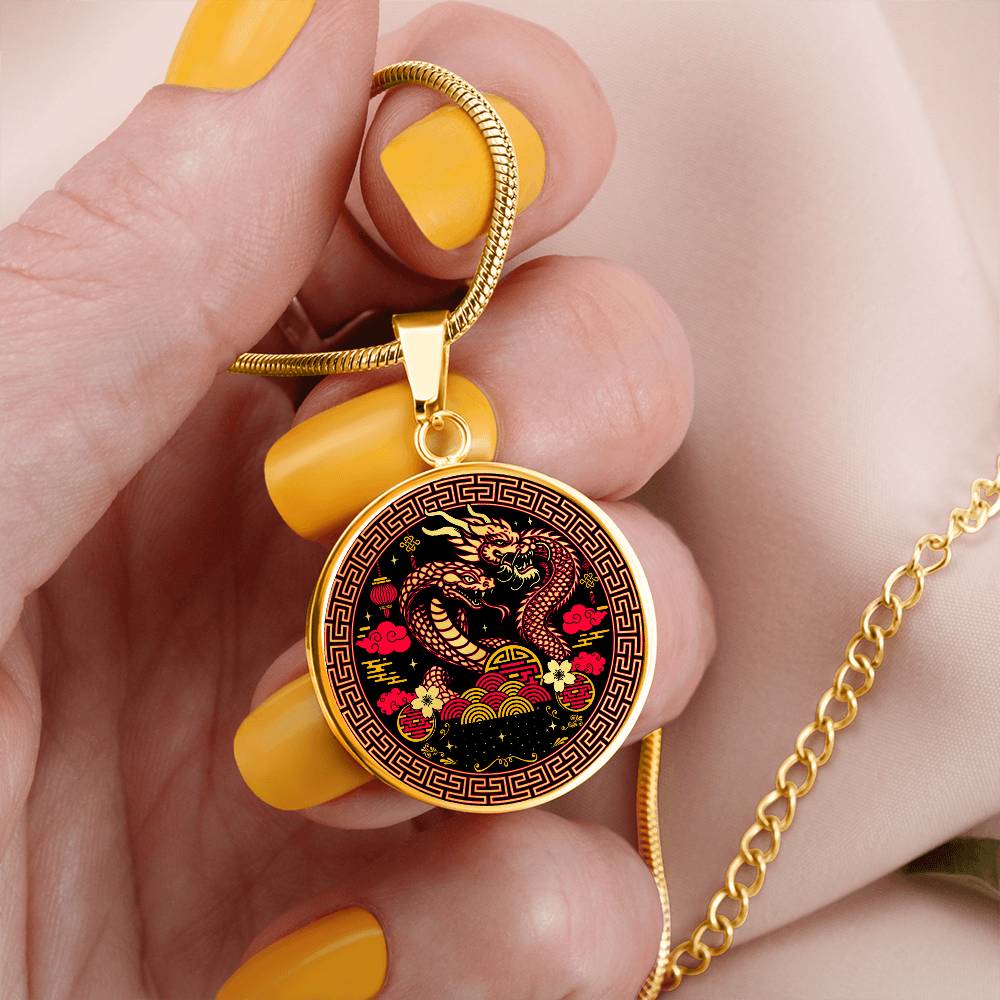 Woman holding An Elegant gold pendant featuring a Year of the Snake and Year of The Dragon Necklace in red, yellow, gold and black. This jewelry offers personalization with an engraving option for a name.