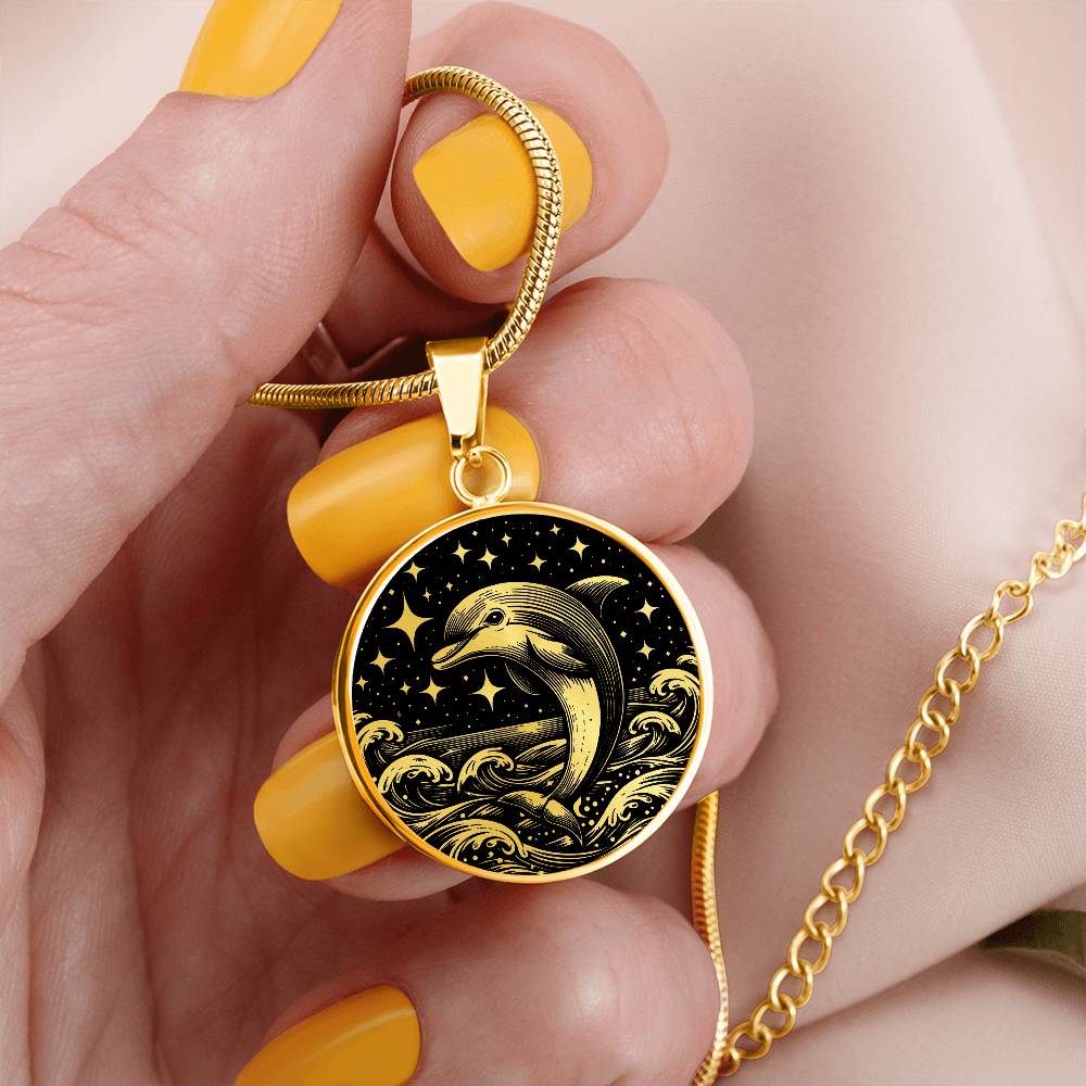 Woman holding an Elegant gold pendant featuring a vivid gold Dolphin Necklace with a Stars and Ocean Waves set against a gold and black backdrop. This jewelry offers personalization with an engraving option for a name.
