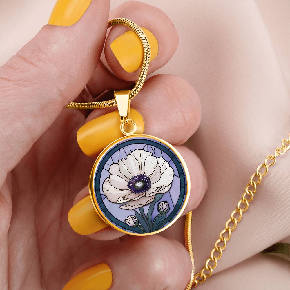 Woman holding an Elegant gold pendant Anemone Necklace. The Colors are Purple Gray, Dark Green. This jewelry offers personalization with an engraving option for a name.