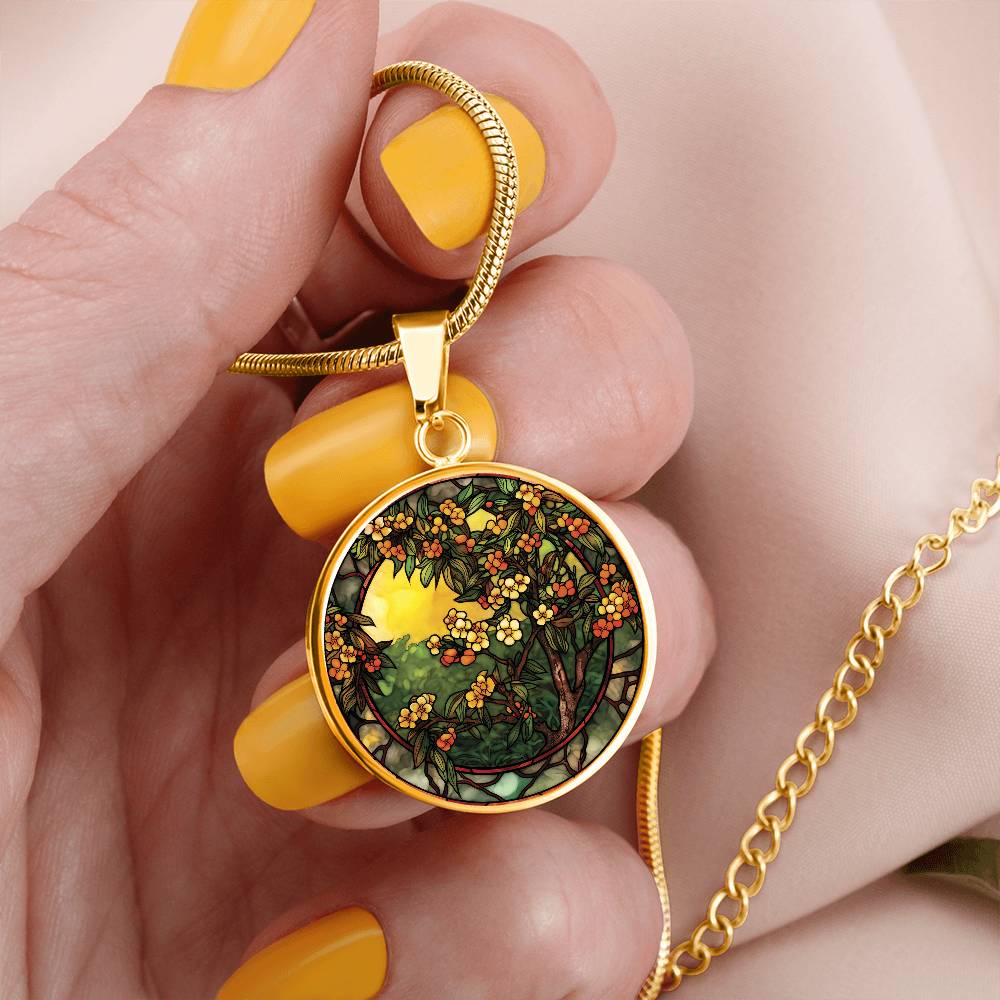 Woman holding An elegant gold pendant Hawthorn Necklace. Colors yellow Flowers and Sky, Green Leaves, Brown branches, Orange Berries & Flowers. This jewelry offers personalization with an engraving option for a name.