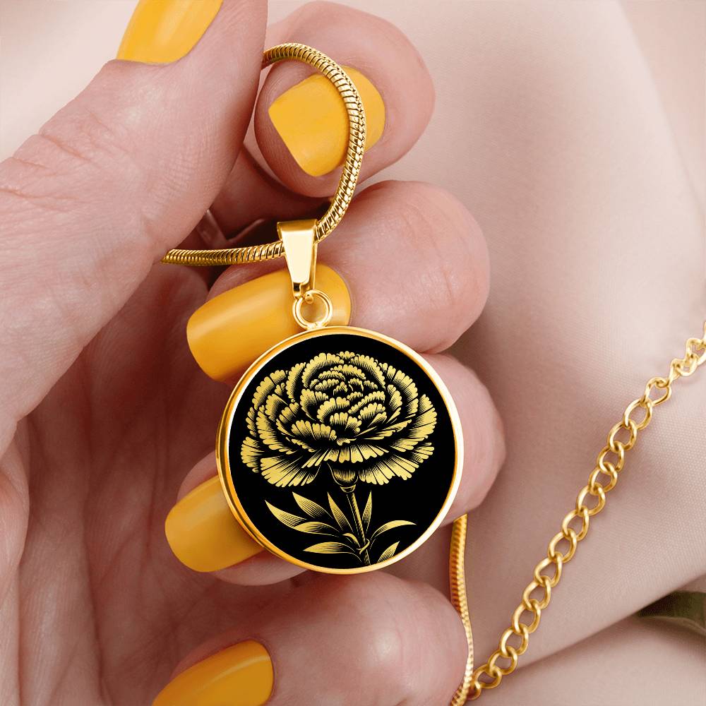 woman holding an Elegant January gold pendant Carnation Birth Flower necklace featuring a vivid gold flower, set against a black backdrop. This jewelry offers personalization with an engraving option for a name.