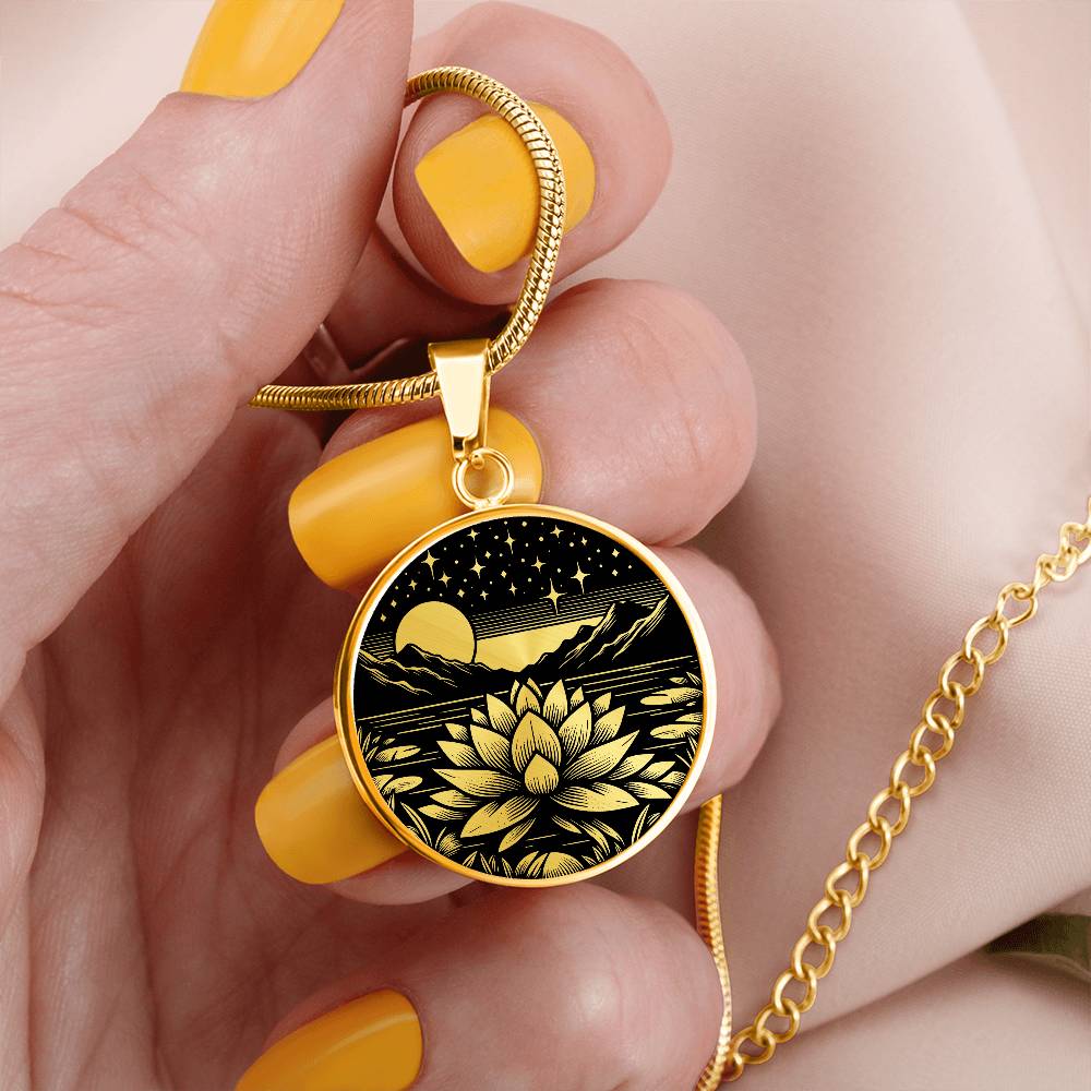Woman holding An Elegant gold pendant Water Lily Necklace featuring Mountains, Stars, Moon, Lily Pads, Water lilies all in black and gold. This jewelry offers personalization with an engraving option for a name.