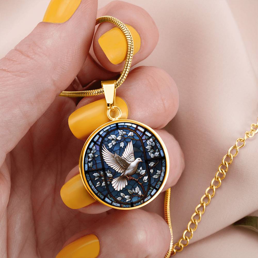 Woman holding an elegant gold pendant White Dove Necklace. The Colors are white, brown and blue This jewelry offers personalization with an engraving option for a name.