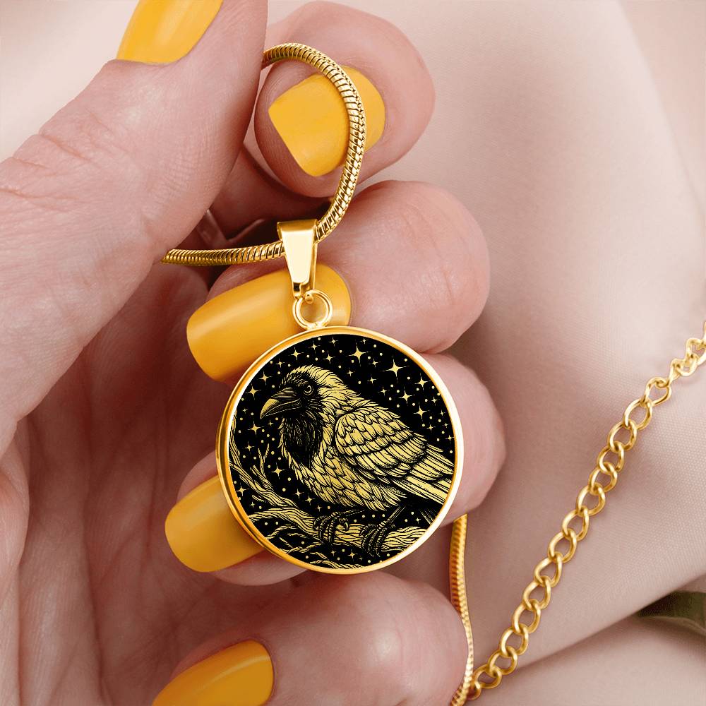 Woman holding an elegant gold pendant Crow Necklace. The colors are gold and black. This jewelry offers personalization with an engraving option for a name.